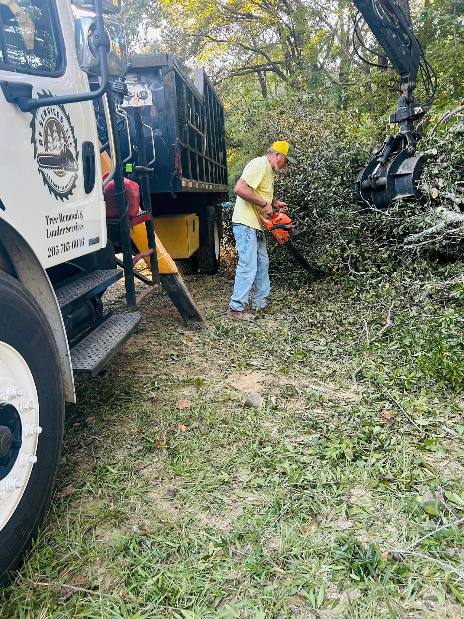 RF Services crew with chainsaw next to branded truck