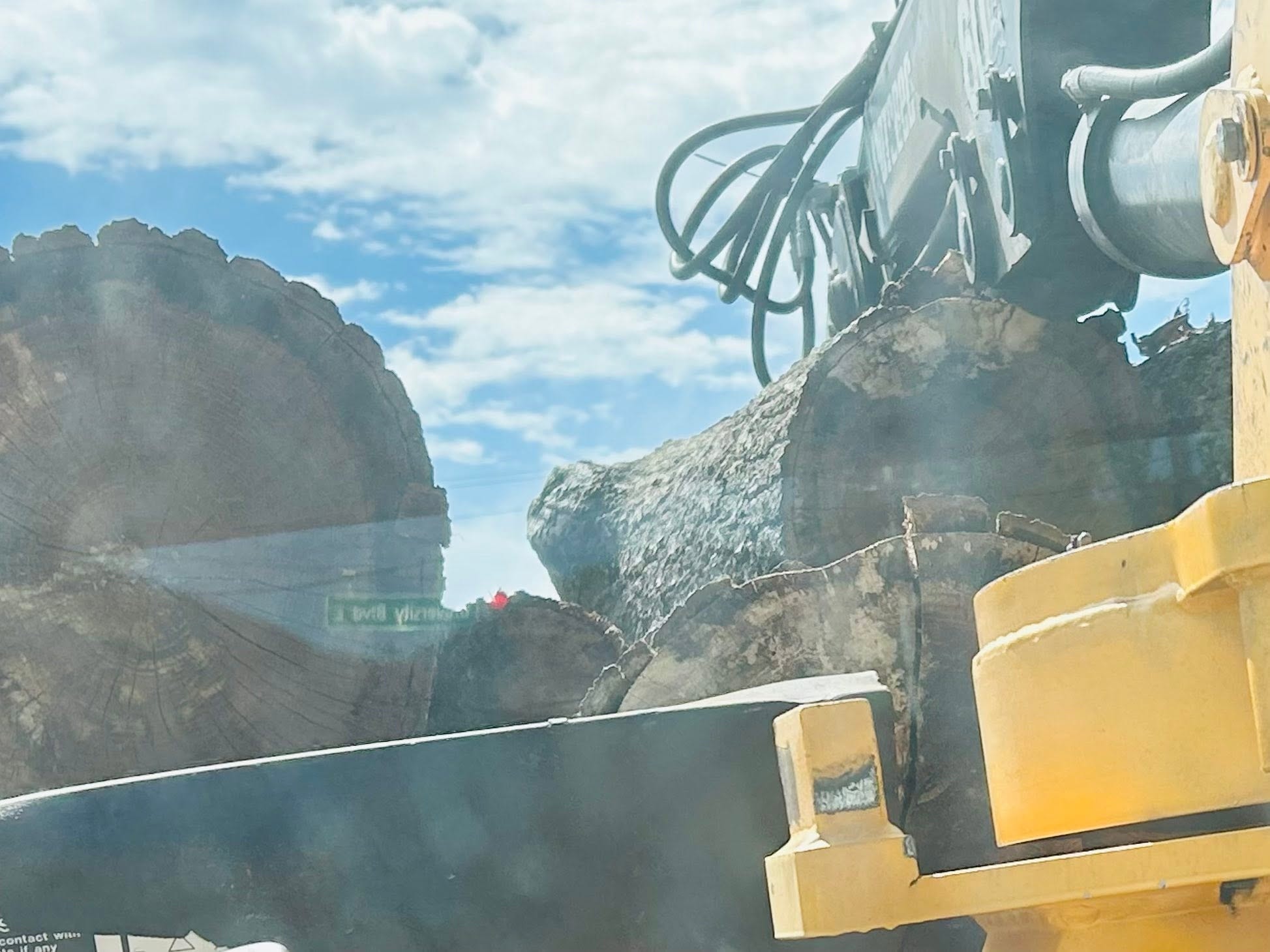 RF Services grapple gripping large tree stump close-up