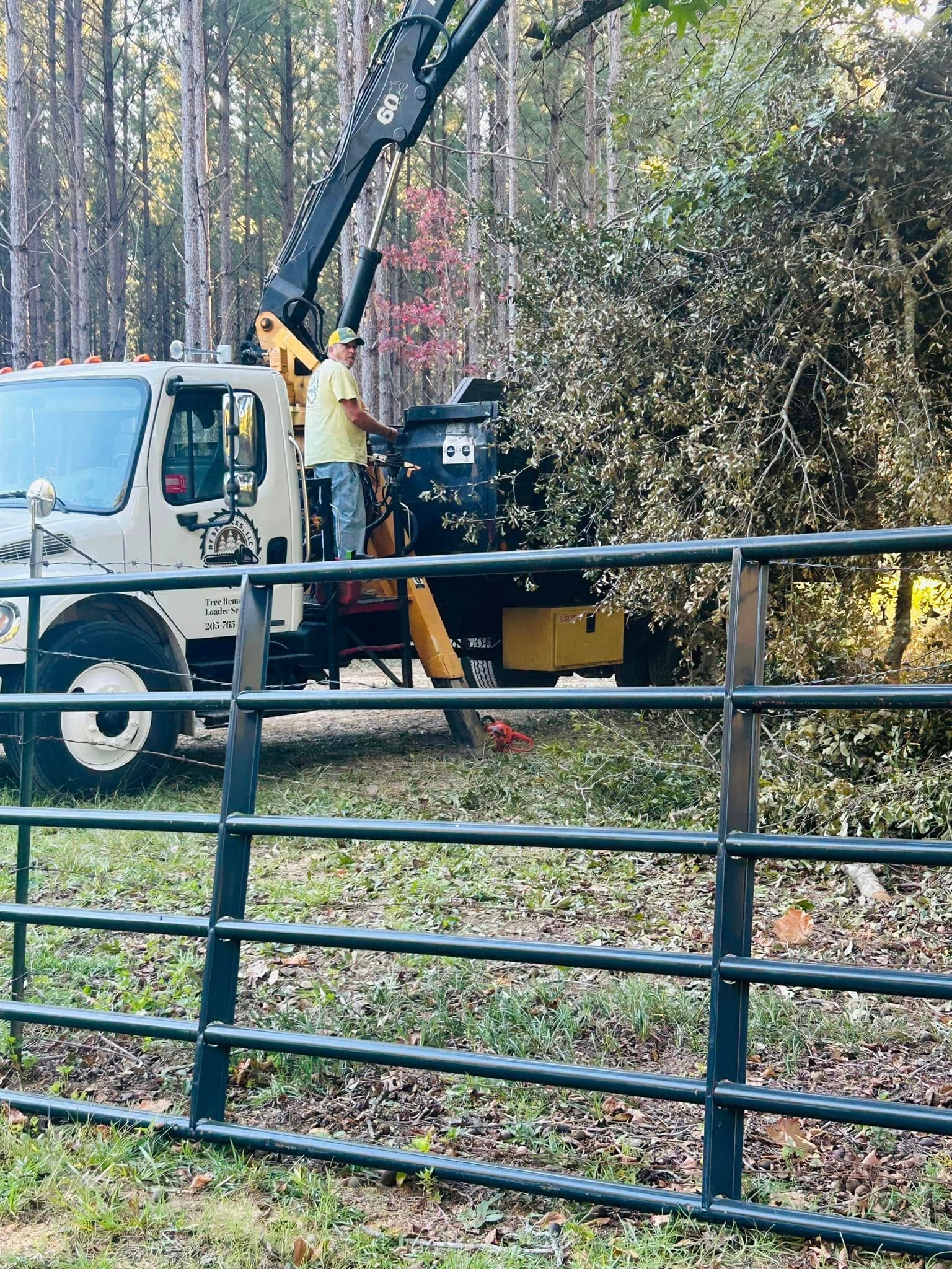 RF Services loader truck clearing along fence line