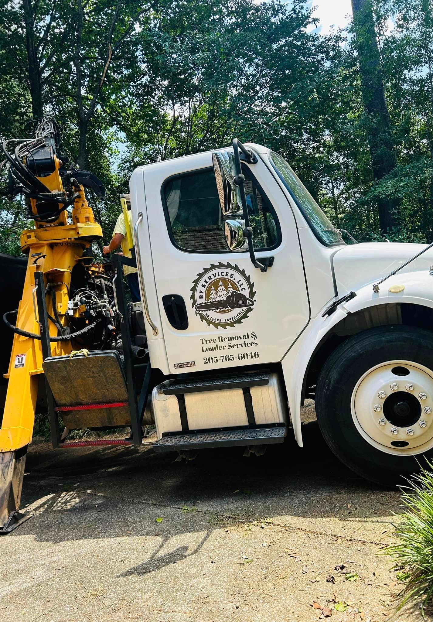 RF Services LLC branded truck and loader