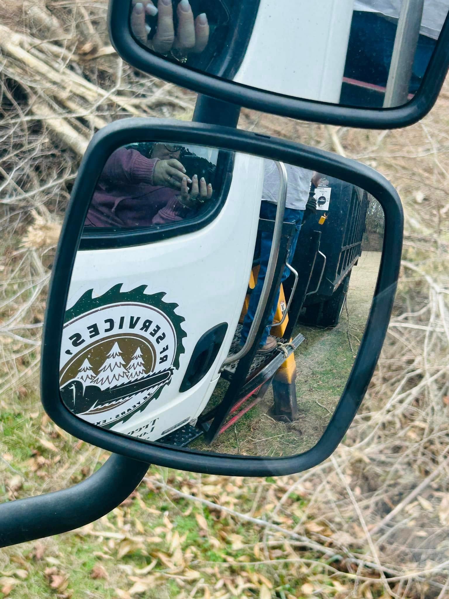 RF Services LLC logo reflected in truck side mirror on job site